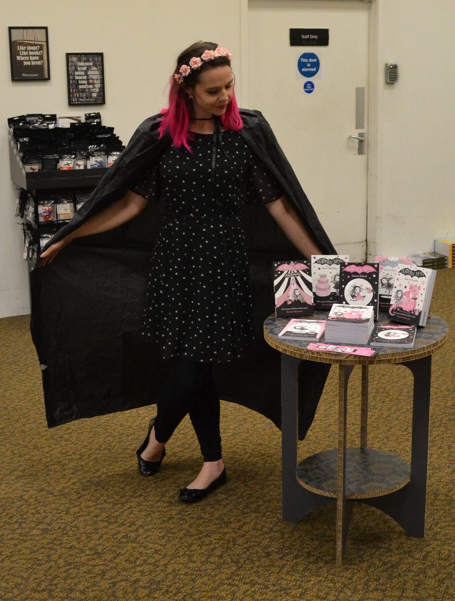 The Isadora Moon display table and me wearing Henry's vampire cape
