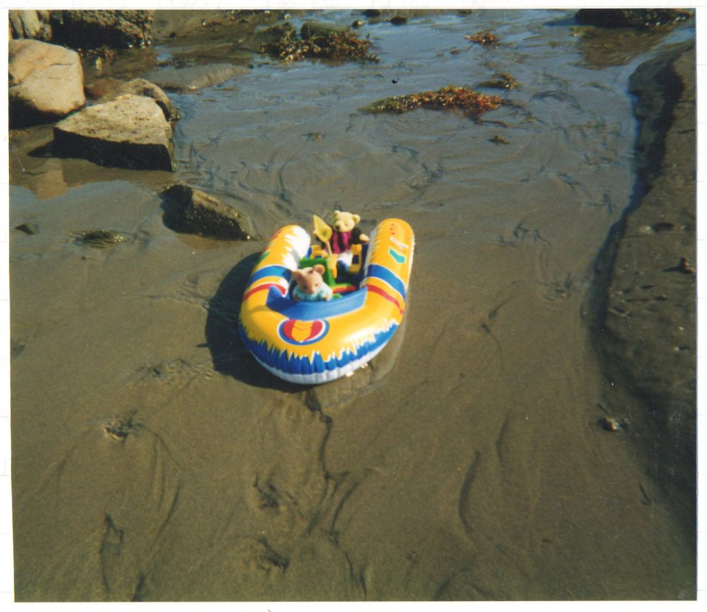 Harriet Muncaster sending mascots down the stream in a boat