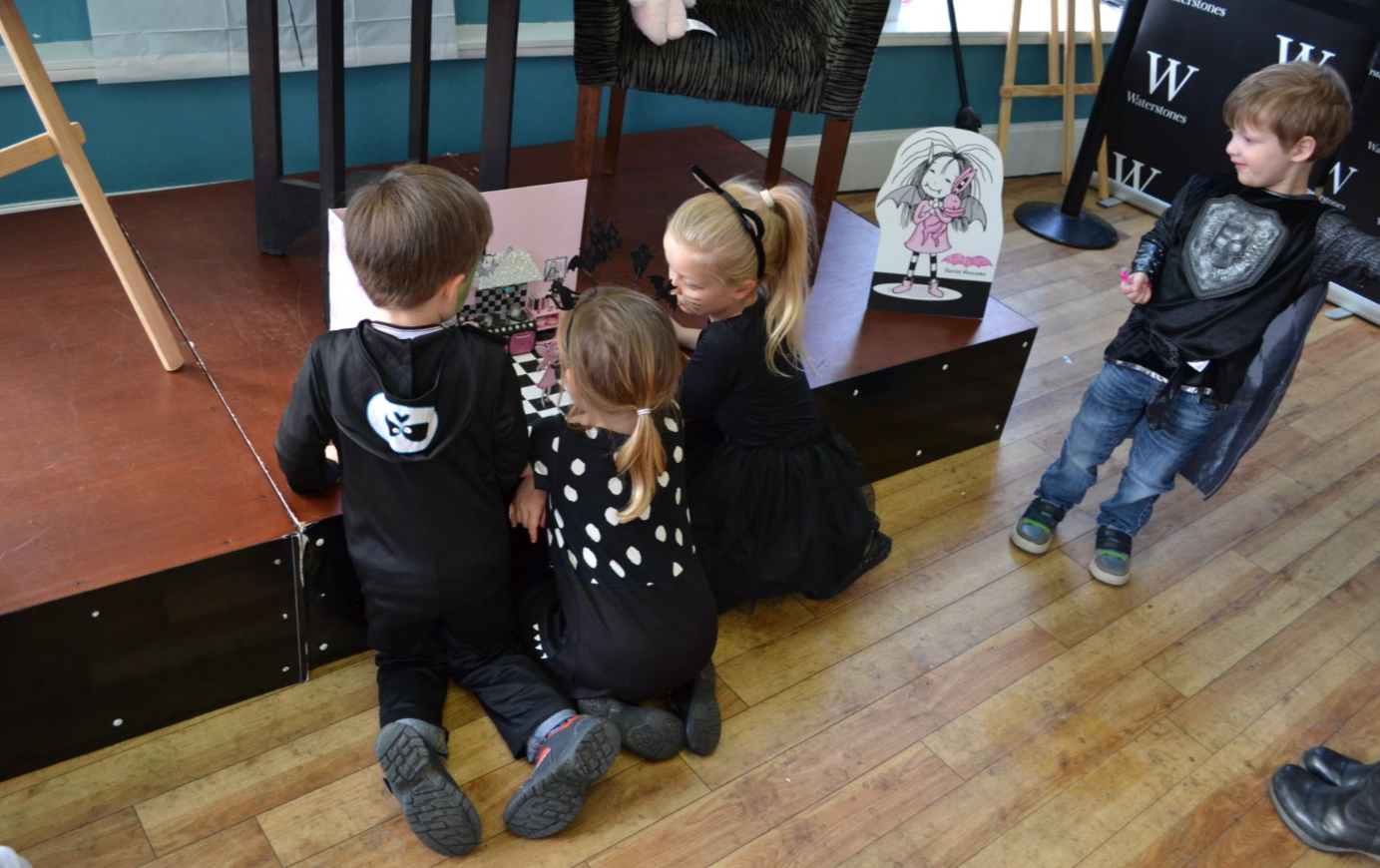 Children admiring Isadora Moon's kitchen at Manchester Waterstones Halloween Party