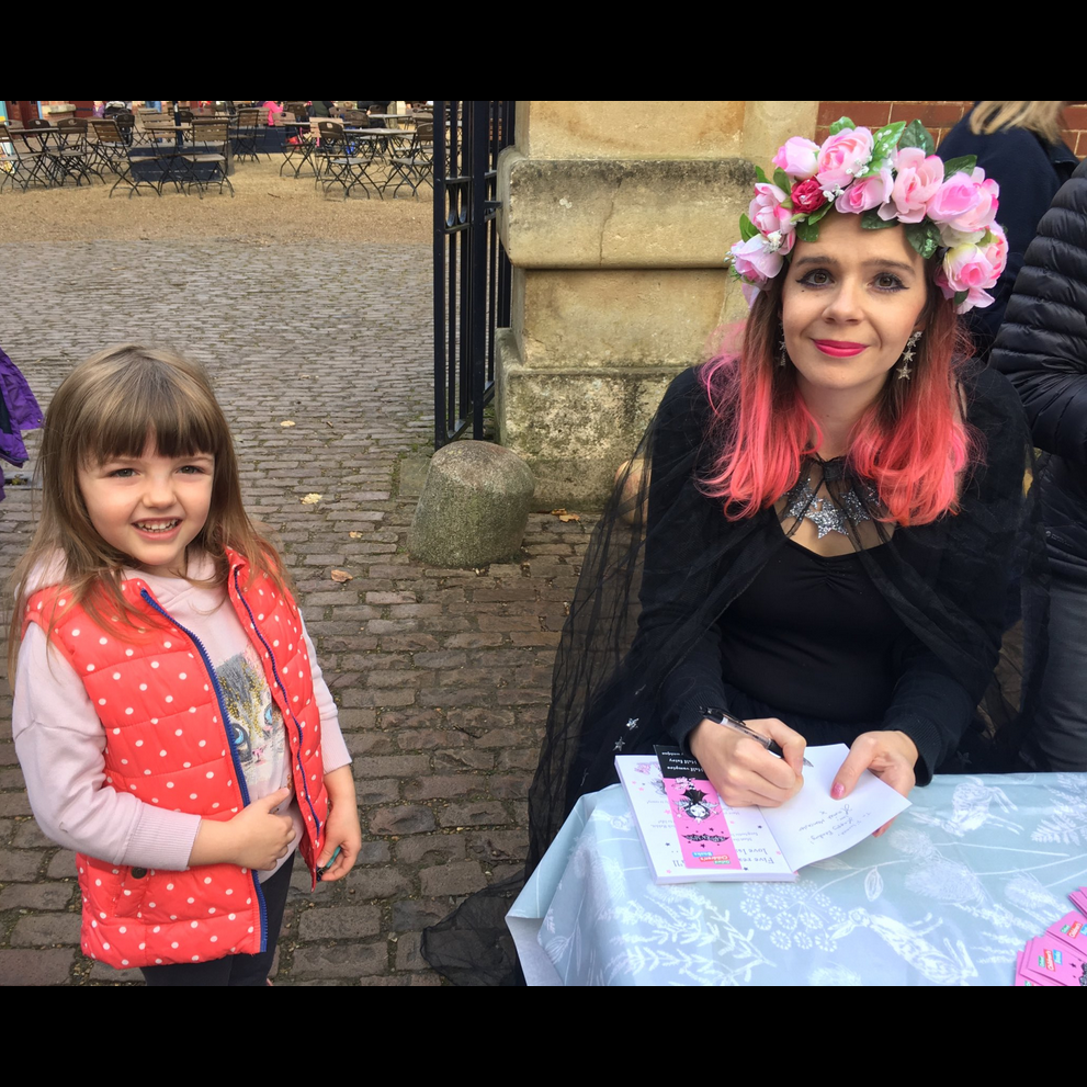 Harriet Muncaster signing a copy of Isadora Moon at Waddesdon Maor