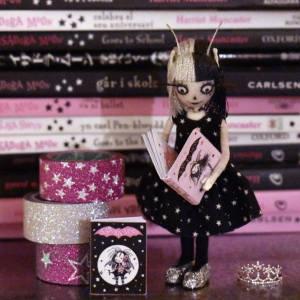 Vinetta reading Isadora Moon Mini Book