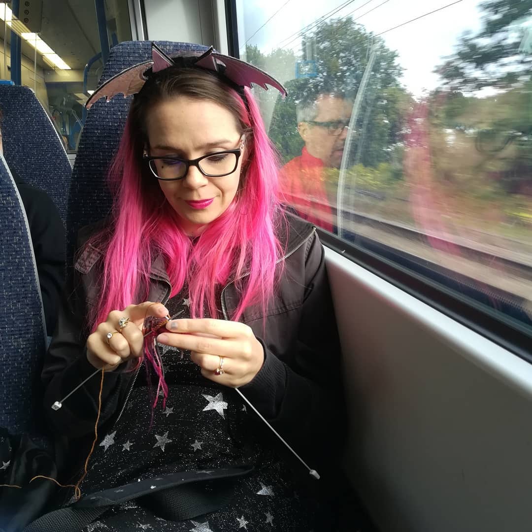 Harriet Muncaster knitting on train