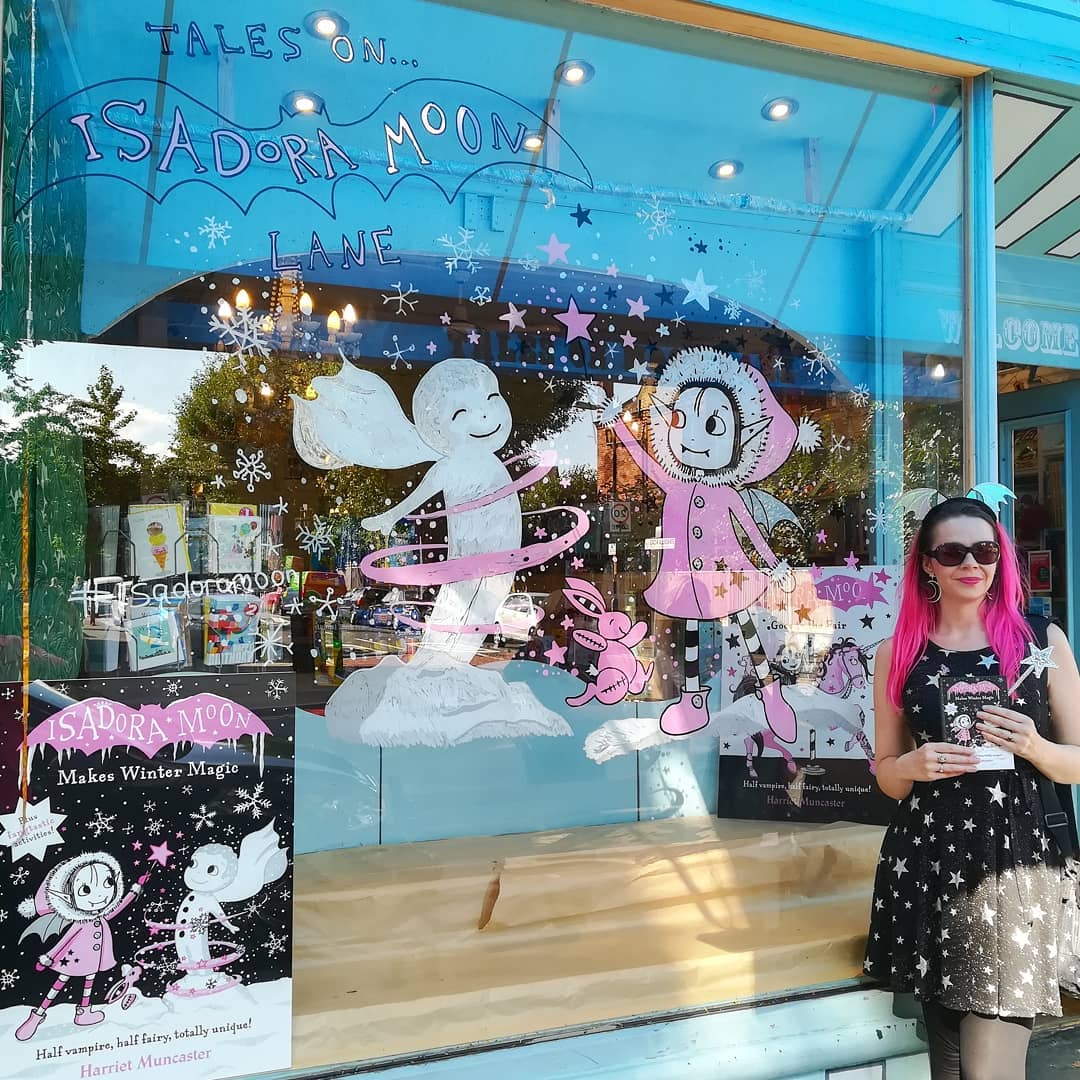 Harriet Muncaster with window display for Tales on Moon Lane