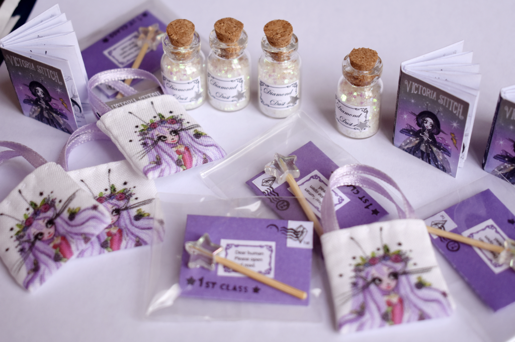 Jars of diamond dust and wiskling tote bags in the Victoria Stitch miniature goody bags