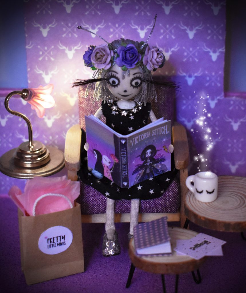 A wiskling reading a Victoria Stitch mini book A wiskling reading a Victoria Stitch mini book